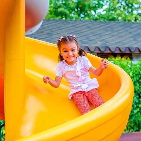 Red and yellow interactive playground equipment with blue wheel